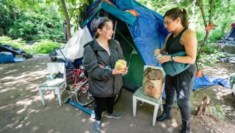 Draya LaMacchia (left) speaks with homeless advocate Sephanie Sena at a homeless. encampment in Norristown.