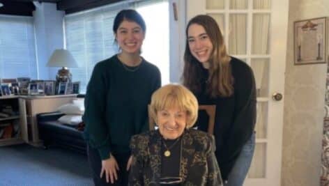 Bryn Mawr College junior Cavan Helmering and Haverford College student Callie Rabins visiting with 94-year-old Betty Sved.