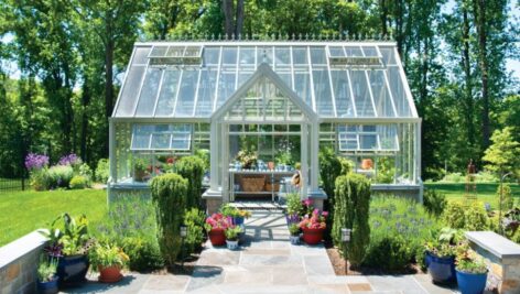 A transformed Delaware County yard with landscaping an a greenhouse.