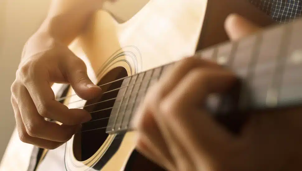 Playing guitar.