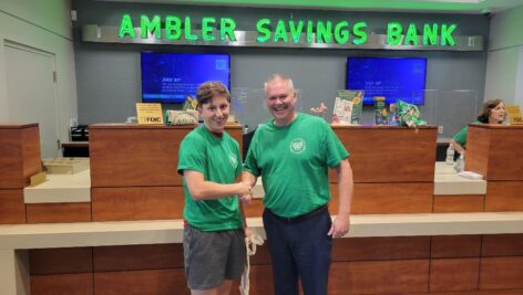 A teenager and man in an Ambler Savings Bank location.
