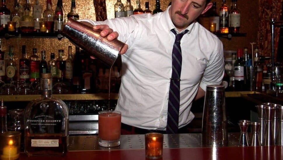 A bartender pours a drink at the The Ranstead Room.