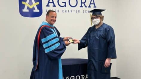 Zusil Atkins of Lower Merion receives an award from Agora CEO Dr. Rich Jensen.