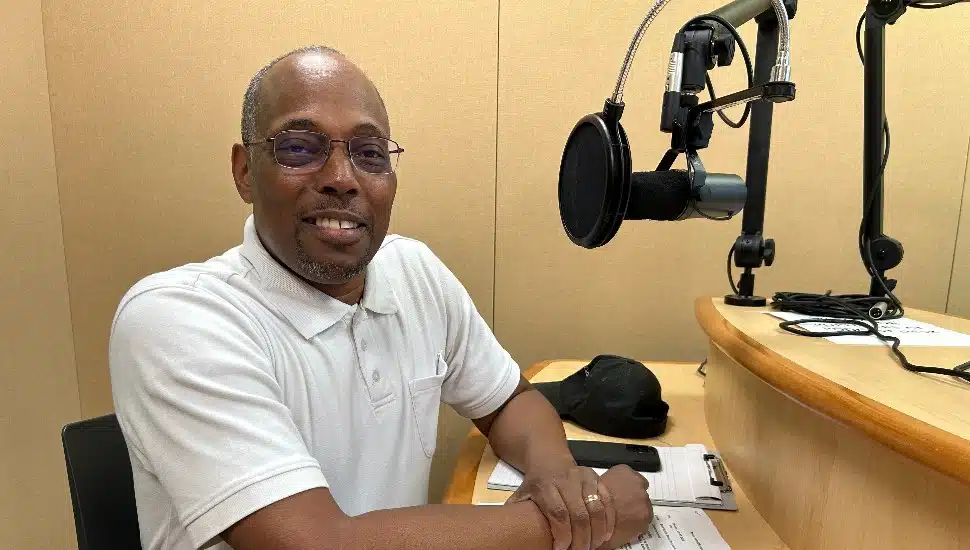 Brent woods sitting near microphone