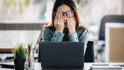 Concept Burnout Syndrome. Business Woman feels uncomfortable working. Which is caused by stress, accumulated from unsuccessful work And less resting body.