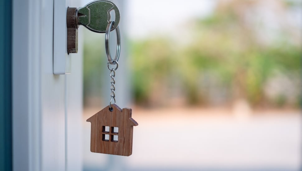 key in door of home.