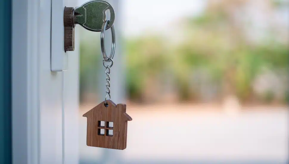 key in door of home.