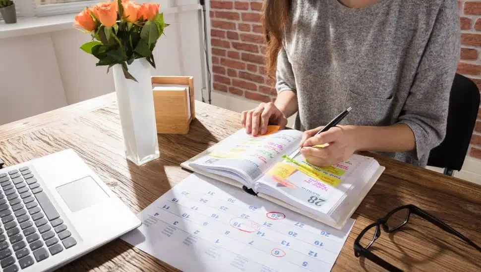 woman writing down reminders, calender