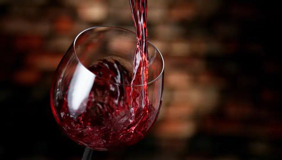 Wine being poured into a glass.