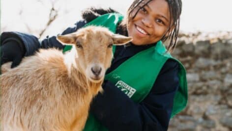 A young person with a goat