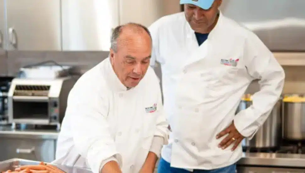 Mike Bowman, president and CEO of the Valley Forge Tourism and Convention Board, left, and Ken Lawrence, Montgomery County Board of Commissioners chairman in the kitchen at Cecil & Grace Bean’s Soup Kitchen in Norristown, Aug. 25.
