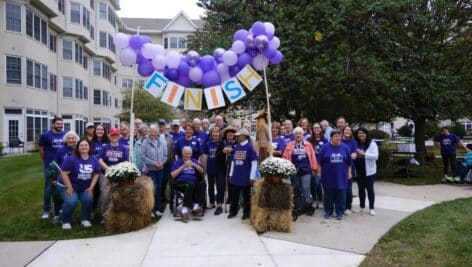 Participants of the Freedom Village Alzheimer's Walk celebrate at the end of the walk.