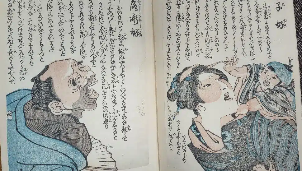 Photo of manga book of "comic stories" on colored woodblock prints