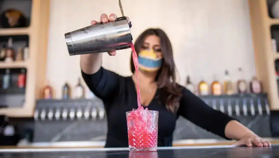 bartender pouring a Mocktails at Lola's Garden.