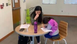 A tutor helping a student with math problems.