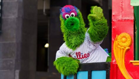 The Phillie Phanatic waves to the crowd at the 102nd annual Thanksgiving Day Parade.