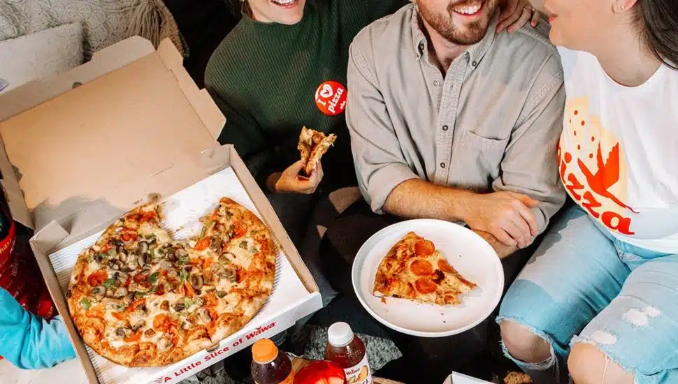 People enjoying Wawa pizza.