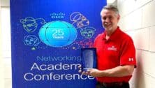 Larry Byron holding award at academy conference
