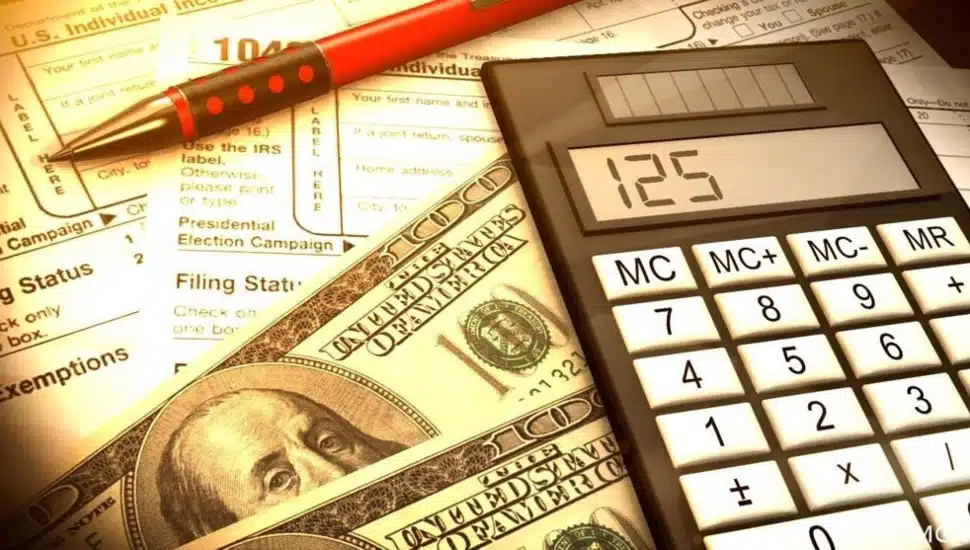 Tax prep with calculator and cash.