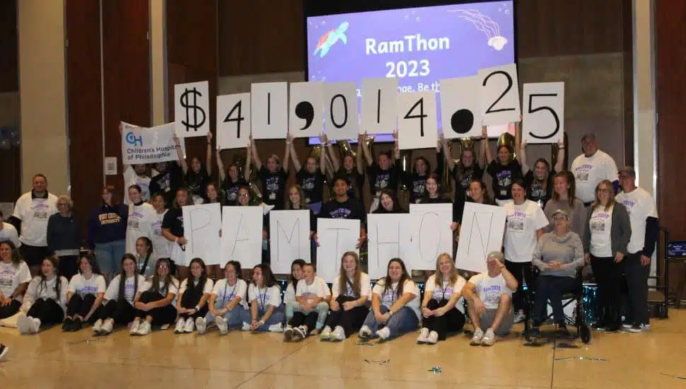 students holding donation amount to CHOP