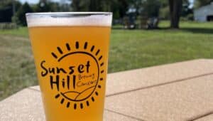 A brew from Sunset Hill Brewing Company on a table outside on the farm.