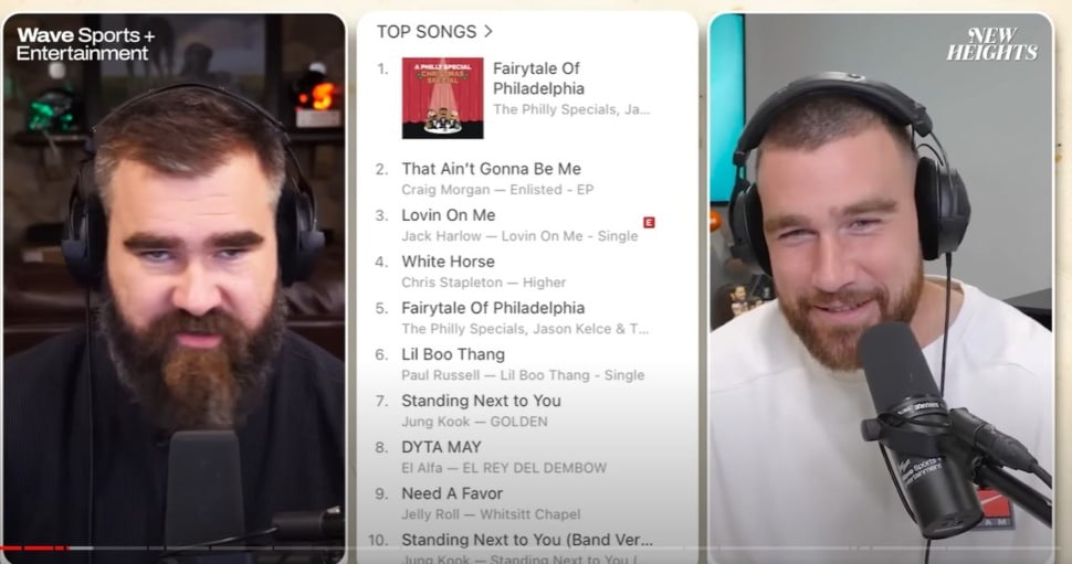 Kelce brothers Jason and Travis show an iTunes chart with "Fairytale of Philadelphia" No. 1 during a New Heights podcast.