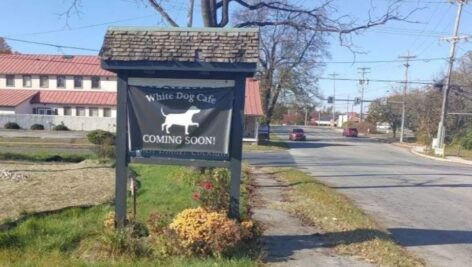 Coming soon sign for new White Dog Cafe location.