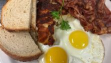 overhead view of breakfast plate spread, two sunny side up eggs, hashbrowns and toast from Jake's eatery