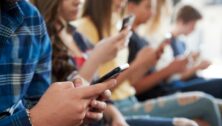 Students using cell phones in school.