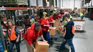 Giant employees and other volunteers pack food boxes at Helping Harvest, 117 Morgan Drive, Spring Township.