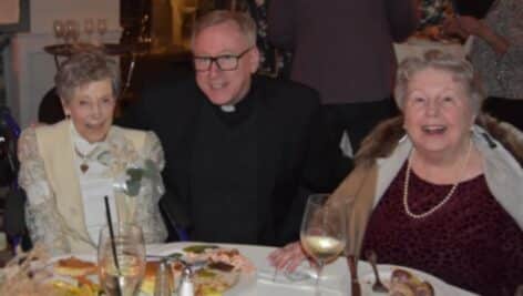 Jane Young, the 84th annual St. Edmond’s Cup Day honoree shares a moment with Rev. William G. Donovan and Louise Dagit.