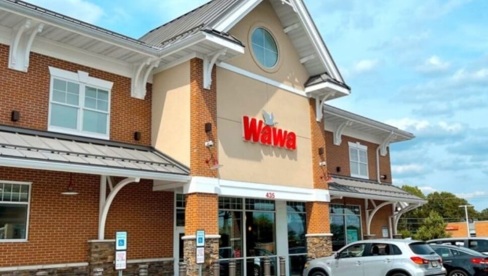 A Wawa store with cars outside.
