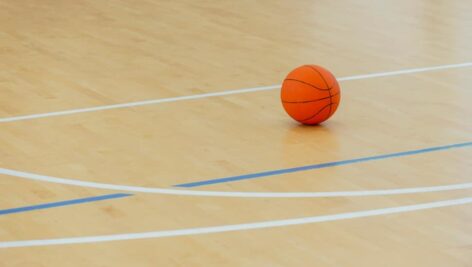 A basketball resting on a basketball court.