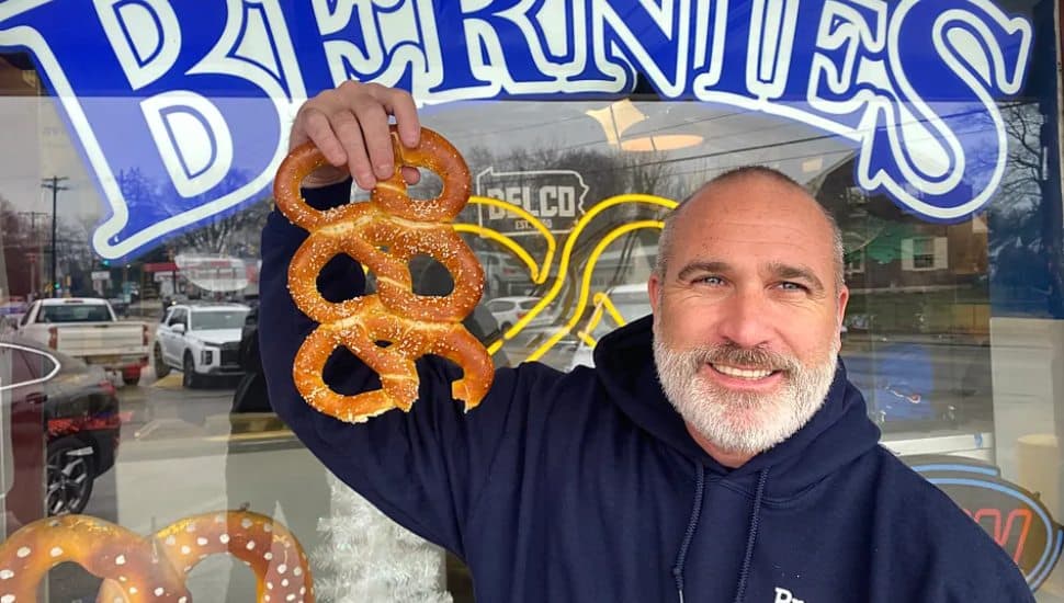 Greg Murray holding up pretzels.