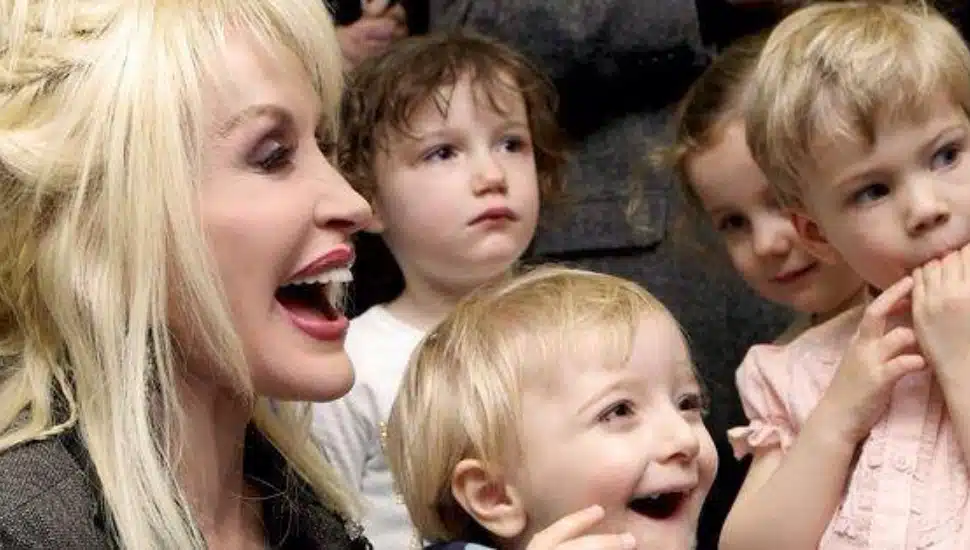 Dolly Parton pictured with a group of children.