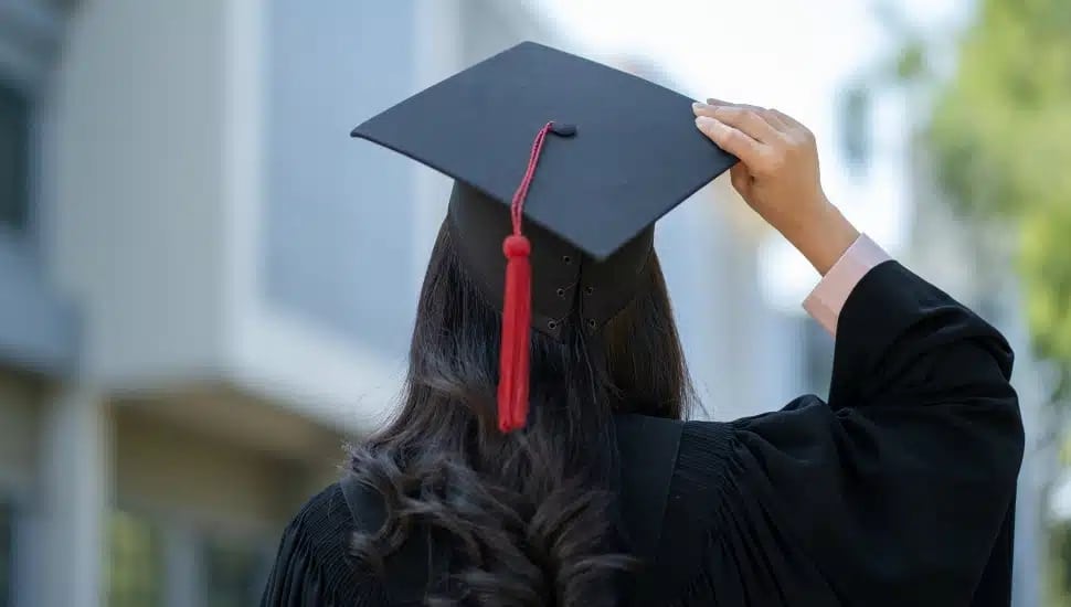 A young woman in a graduation cap.