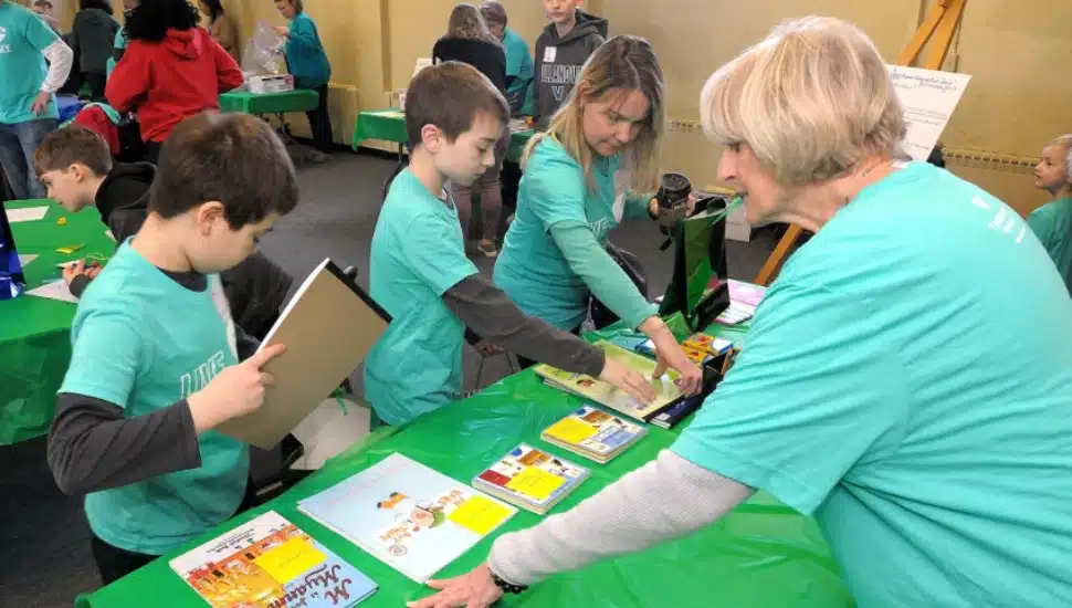 Volunteers assemble “Welcome to America” bags, which include bilingual books, toys and crayons, as part of the Martin Luther King Day of Service at St. John Lutheran Church in Blue Bell in 2019.