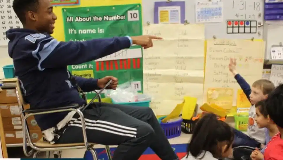 North Penn football players reading to kids.