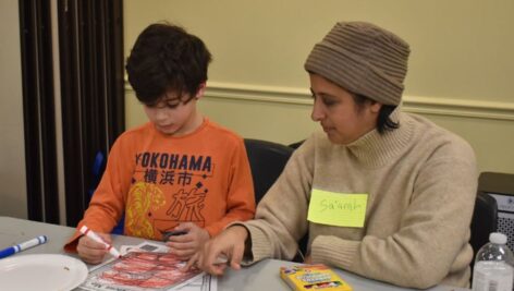 A mother and child attended a workshop presented by Penn State Abington education majors that offered evidence-based support for parents on selecting diverse literature for their children
