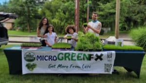 Sergio Kuik and his family selling microgreens.