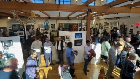 students, parents, and teachers at art show.