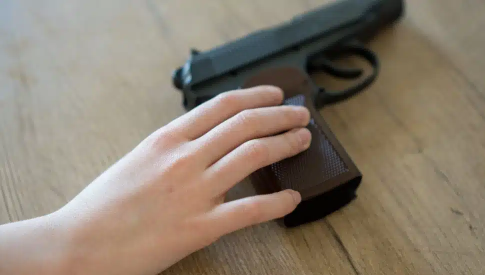 A hand on a gun.
