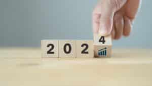 2024 business growth concept. New year business goals, plan and strategy. Flipping wooden cubes to 2024 and growth performance. Banner for the new action plan ,annual plan, growth, target.