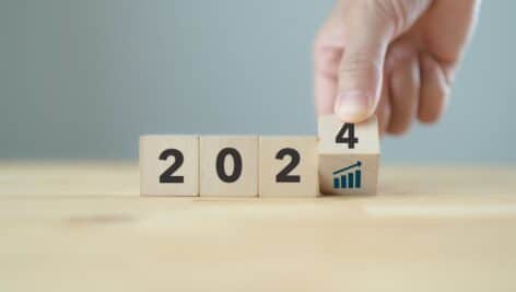 2024 business growth concept. New year business goals, plan and strategy. Flipping wooden cubes to 2024 and growth performance. Banner for the new action plan ,annual plan, growth, target.