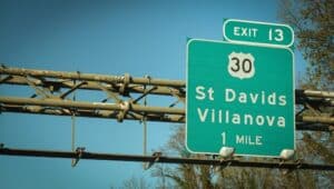 A highway sign indicating the exit for Villanova and St. David's and to the most expensive neighborhood in Pennsylvania.