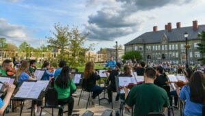 Students in WCU's Wells School of Music performing outside.