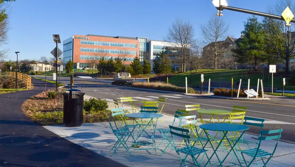 trendy outdoor tables in foreground with office building in background