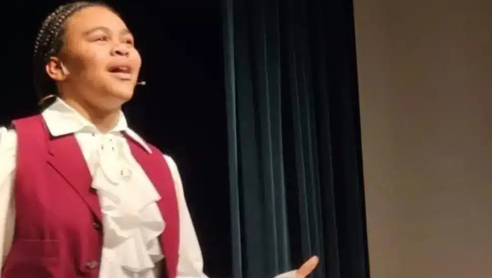 Mikayla performing on stage as Gaston