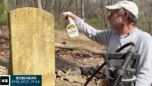 man cleaning gravestone