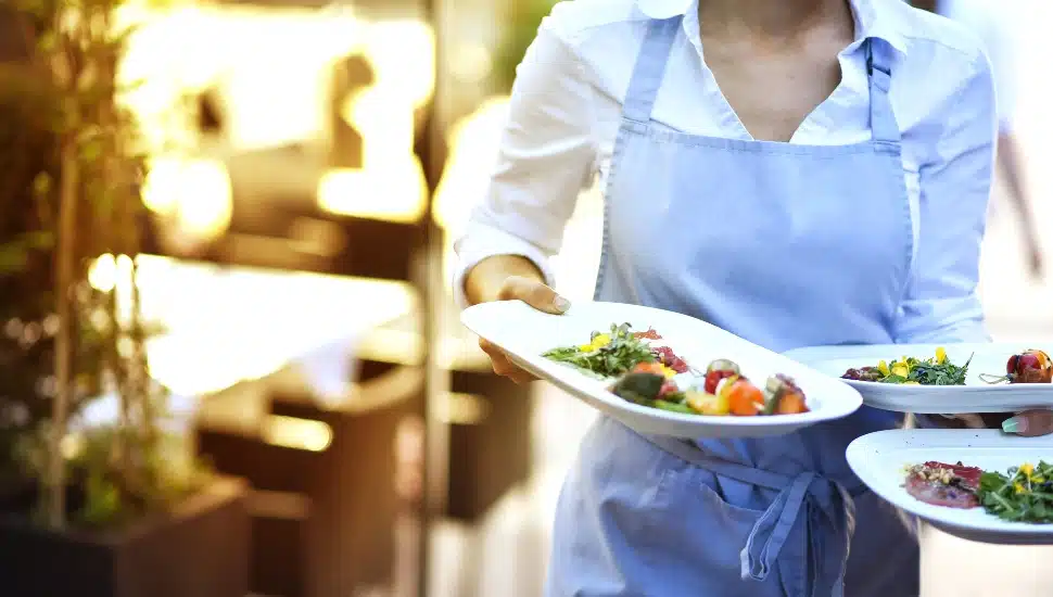 Waitress bringing dishes to a table